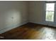 A bright bedroom with a window and wooden floor at 223 S Main St, Wendell, NC 27591
