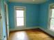 This bedroom features two windows and wood floors at 223 S Main St, Wendell, NC 27591