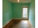 This bedroom is equipped with a single window and wooden floor at 223 S Main St, Wendell, NC 27591