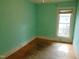 A bedroom with a window and wooden floor at 223 S Main St, Wendell, NC 27591