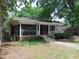 Charming brick home with a screened-in porch and a well-maintained front yard at 223 S Main St, Wendell, NC 27591