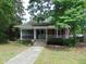 Inviting brick home with a screened-in porch, landscaped yard, and classic architectural details at 223 S Main St, Wendell, NC 27591