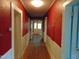 Hallway with a red walls, white trim, and doors at 223 S Main St, Wendell, NC 27591