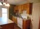 Kitchen featuring wooden cabinets, white appliances, and a center island at 223 S Main St, Wendell, NC 27591