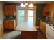 Kitchen with a center island, wooden cabinets, and a white electric stove at 223 S Main St, Wendell, NC 27591