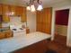 Kitchen with a center island, wooden cabinets, and a white electric stove at 223 S Main St, Wendell, NC 27591
