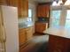 Kitchen featuring wooden cabinets, white appliances, and a center island at 223 S Main St, Wendell, NC 27591