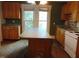 Kitchen with a center island, wooden cabinets, and a white electric stove at 223 S Main St, Wendell, NC 27591