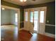 Open living room showcases hardwood floors, fireplace, ceiling fan, and view of the porch at 223 S Main St, Wendell, NC 27591