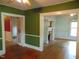 Spacious living room with hardwood floors, fireplace, ceiling fan, and multiple entryways at 223 S Main St, Wendell, NC 27591