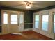 This living room offers hardwood floors, a ceiling fan, and views from multiple windows at 223 S Main St, Wendell, NC 27591