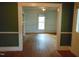 Large, light-filled living room featuring hardwood floors, and a view to fireplace at 223 S Main St, Wendell, NC 27591