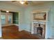 Vintage-style living room featuring hardwood floors and a decorative fireplace with mantel at 223 S Main St, Wendell, NC 27591