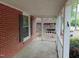 View of front brick porch with white railings, brick columns, and a glimpse of the side yard at 223 S Main St, Wendell, NC 27591