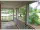 Spacious covered front porch with white railings, offering a view of the neighborhood at 223 S Main St, Wendell, NC 27591