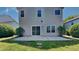 Backyard view featuring a sliding door and a concrete patio surrounded by grass and shrubbery at 2428 Diquedo Dr, Raleigh, NC 27604