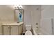 A well-lit bathroom with a vanity, mirror, toilet, and shower-tub combo at 2428 Diquedo Dr, Raleigh, NC 27604