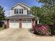 Charming two-story home with a brick facade, two-car garage, and landscaped front yard at 2428 Diquedo Dr, Raleigh, NC 27604