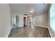 A spacious hallway with hardwood floors and neutral paint leads to multiple rooms at 2428 Diquedo Dr, Raleigh, NC 27604