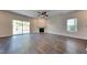 Spacious living room with wood floors, fireplace, ceiling fan, and sliding door to the backyard at 2428 Diquedo Dr, Raleigh, NC 27604