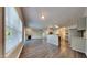 Open-concept living room with wood floors, fireplace, and seamless flow to the updated kitchen at 2428 Diquedo Dr, Raleigh, NC 27604