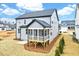 Backyard view of gray two-story home with sunroom and nice landscaping at 2437 Terri Creek Dr, Fuquay Varina, NC 27526