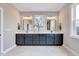 Elegant bathroom with double vanities, modern lighting, and a serene atmosphere, perfect for relaxation at 2437 Terri Creek Dr, Fuquay Varina, NC 27526