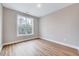 Bright and airy bedroom with large window and hardwood floors, offering a peaceful retreat at 2437 Terri Creek Dr, Fuquay Varina, NC 27526
