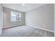 Serene bedroom with carpet, a large window for ample natural light, and a neutral color palette at 2437 Terri Creek Dr, Fuquay Varina, NC 27526