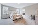 Spacious bedroom with plush carpet, a sitting area, and a bright bathroom, designed for comfort and style at 2437 Terri Creek Dr, Fuquay Varina, NC 27526