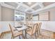 Elegant dining room with coffered ceilings, neutral décor, and abundant natural light at 2437 Terri Creek Dr, Fuquay Varina, NC 27526