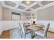 Stylish dining room with coffered ceilings, neutral décor, and artwork on the walls at 2437 Terri Creek Dr, Fuquay Varina, NC 27526