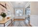 Bright foyer with hardwood floors, white trim, and a view into a dining room with coffered ceiling at 2437 Terri Creek Dr, Fuquay Varina, NC 27526