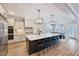 Spacious kitchen with a large island, modern lighting, stainless steel appliances, and a separate dining area at 2437 Terri Creek Dr, Fuquay Varina, NC 27526