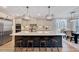 Spacious kitchen with a large island, pendant lighting, stainless steel appliances and wooden bar stools at 2437 Terri Creek Dr, Fuquay Varina, NC 27526