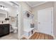 Well-organized mudroom with bench, coat hooks, and storage cubbies, conveniently located near the powder room at 2437 Terri Creek Dr, Fuquay Varina, NC 27526