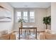 Inviting home office with natural light, desk, and comfortable seating, creating a productive workspace at 2437 Terri Creek Dr, Fuquay Varina, NC 27526
