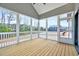 Relaxing sunroom featuring wood flooring, many windows, and outdoor views at 2437 Terri Creek Dr, Fuquay Varina, NC 27526