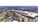 Aerial view showcasing the shopping center, surrounding buildings, and lush green trees in the area at 2507 Princewood St, Raleigh, NC 27612