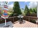 A back deck with wooded backdrop with a grill and umbrella at 2507 Princewood St, Raleigh, NC 27612