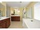 Bright bathroom features dual vanities, soaking tub, and glass-enclosed shower at 2507 Princewood St, Raleigh, NC 27612