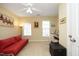 Bright, carpeted bedroom with ceiling fan, sofa, and two windows at 2507 Princewood St, Raleigh, NC 27612
