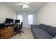 Cozy carpeted bedroom with ceiling fan, sofa, desk, and windows at 2507 Princewood St, Raleigh, NC 27612