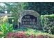 Stone community sign for The Townes at Crabtree surrounded by greenery, flowers, and manicured bushes at 2507 Princewood St, Raleigh, NC 27612