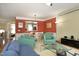 Inviting living room with red accent wall, comfortable seating, and view into the adjacent dining area at 2507 Princewood St, Raleigh, NC 27612