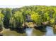Lush wooded property featuring a lakeside residence, mature trees, and stunning natural beauty at 25303 Ludwell, Chapel Hill, NC 27517