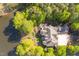 Breathtaking aerial view of the estate, showcasing the sprawling property, lush greenery, and lakefront access at 25303 Ludwell, Chapel Hill, NC 27517