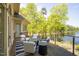 Exterior view of the deck with patio furniture overlooking the lake at 25303 Ludwell, Chapel Hill, NC 27517
