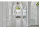 Elegant bathroom with tiled floors, an arched window and a frameless glass walk-in shower at 25303 Ludwell, Chapel Hill, NC 27517