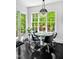 Sun-filled breakfast nook with black-stained wood floor and backyard views at 25303 Ludwell, Chapel Hill, NC 27517